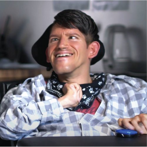 Person sitting in a wheelchair in a flannelette shirt