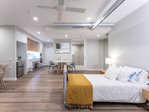 Interior of apartment including bedroom, kitchen, lounge.