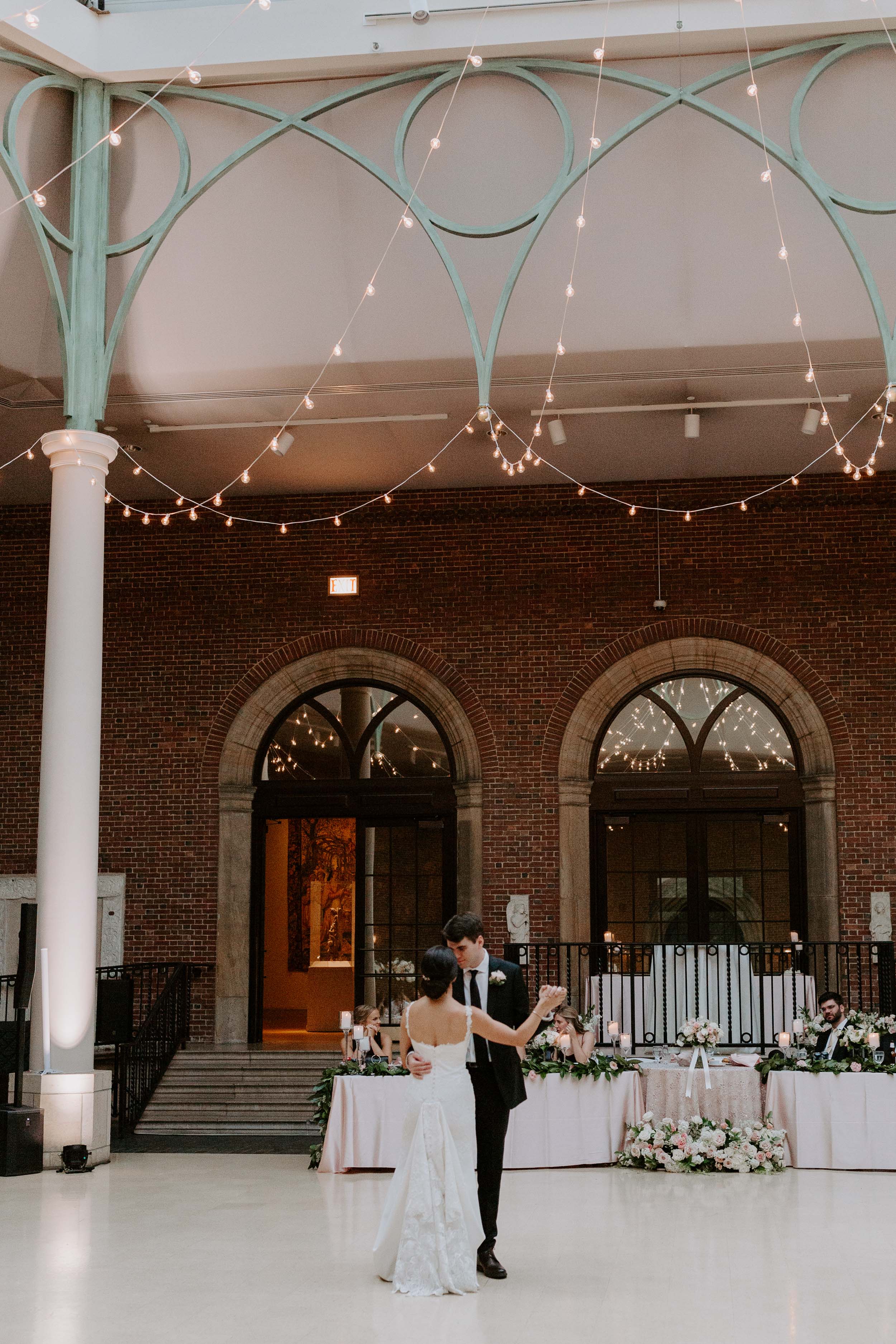 Dayton Art Institute Wedding Reception with florals and string lights in the hexagon-shaped Shaw Gothic Cloister