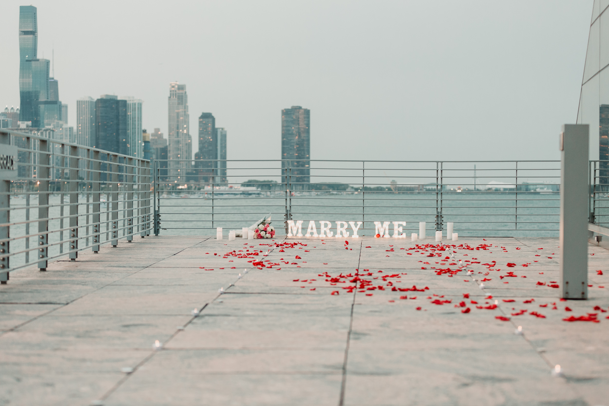 Rose petals leading up to marry me proposal sign | Chicago Skyline Proposal | Proposal Ideas | Chicago Engagement Photographer | Chicago Proposal Photographer | Chicago Proposal | Proposal Stories | How to Propose | She Said Yes | Engaged | Places to Get Engaged in Chicago