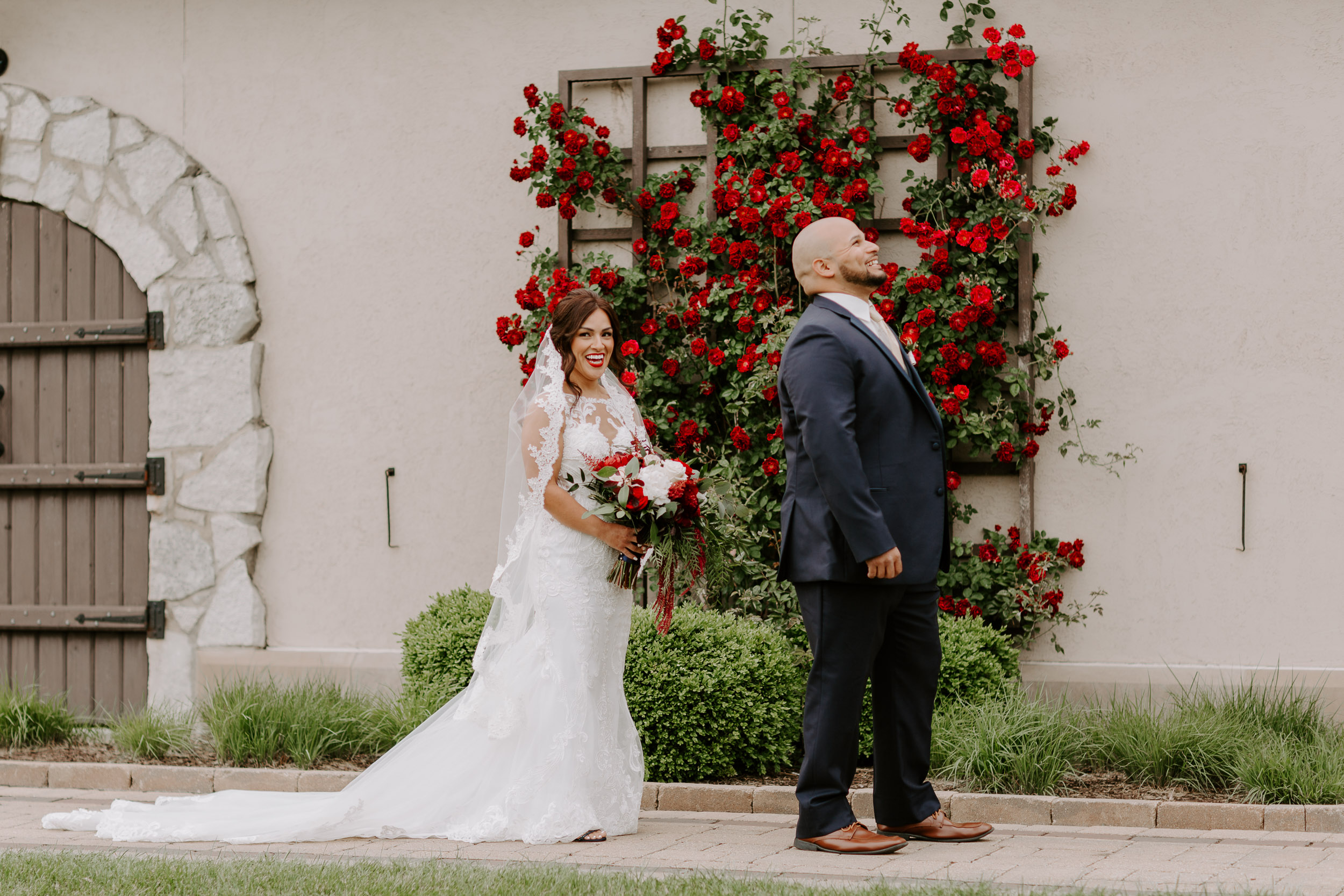 Romantic First Look In Front of Wall of Red Flowers | Mistwood Golf Club Wedding | Chicagoland Country Club Weddings | Best Golf Courses for Weddings
