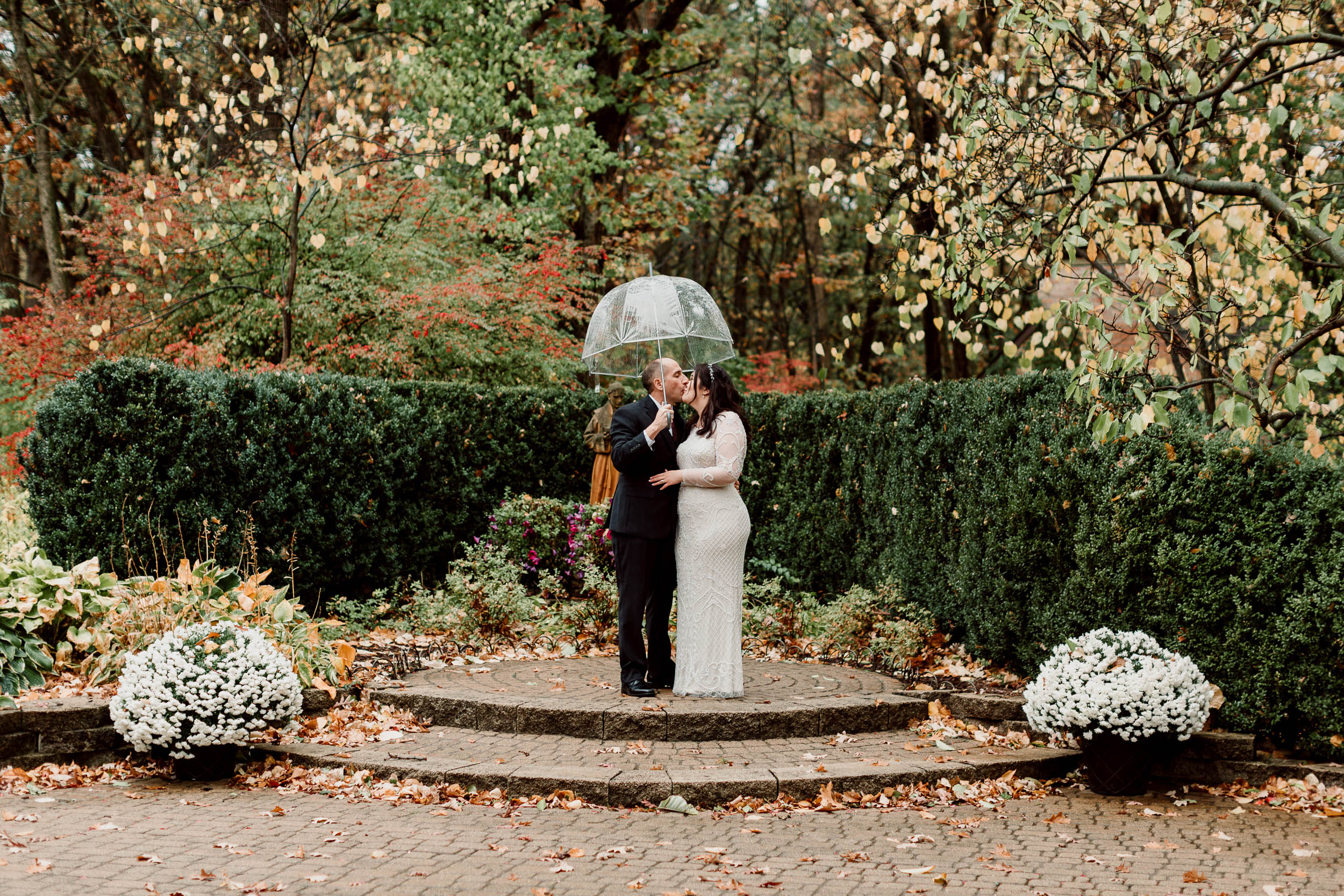 Clear umbrella on a rainy wedding day | 
Intimate Elopement in Palos Park IL | The Wayside Chapel at The Center Wedding | The Center Garden Wedding | Rainy Fall Wedding | Fall Chicago Wedding | Elopement Photographer Chicago