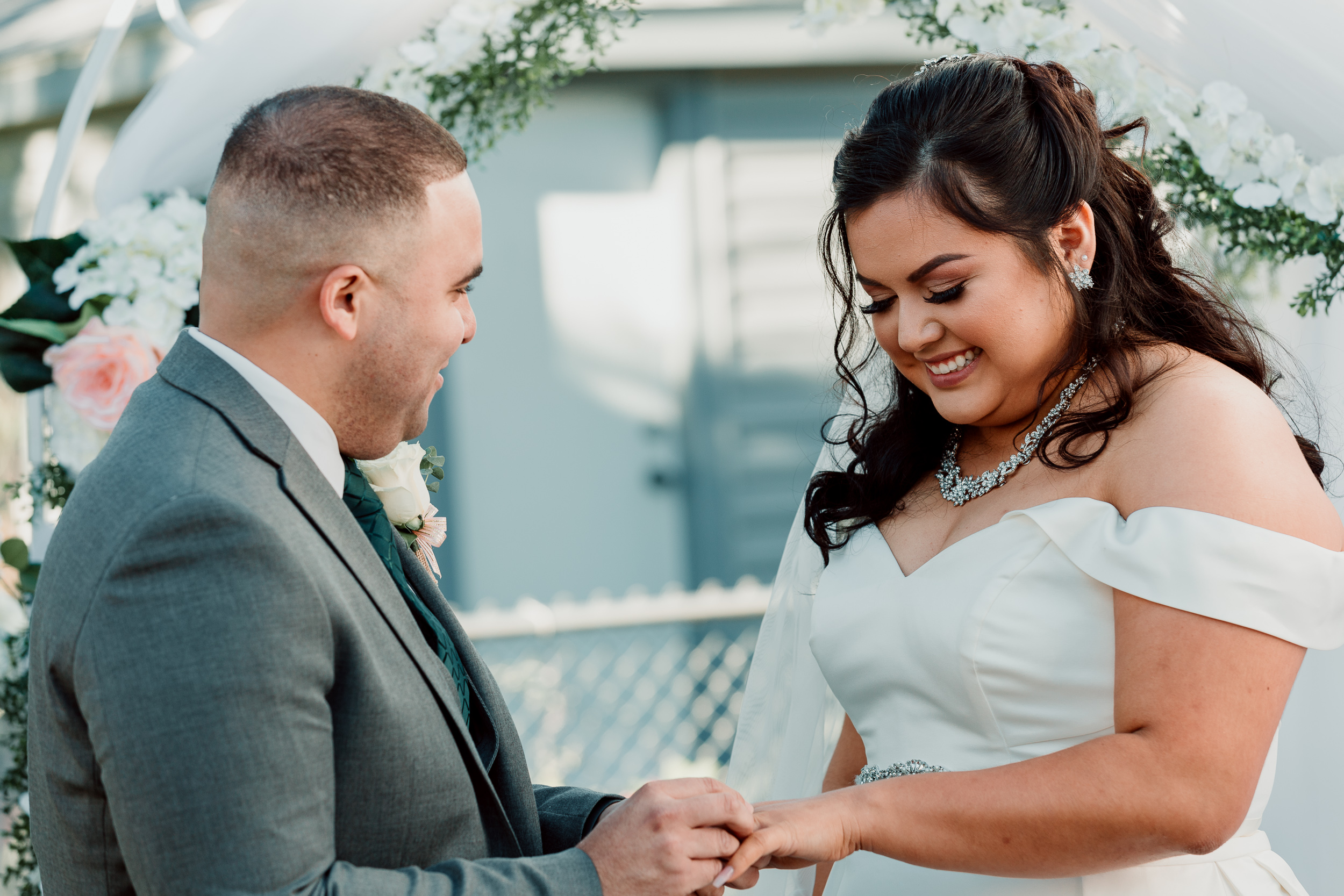 Exchanging vows and rings at wedding ceremony | Backyard Chicago Wedding | Emotional Chicago Wedding | Historic Downtown Riverside Wedding Photos | Chicago Wedding Photographer | Metra Station Wedding Photos | Small Weddings in Chicago | Intimate Elopements in Chicago