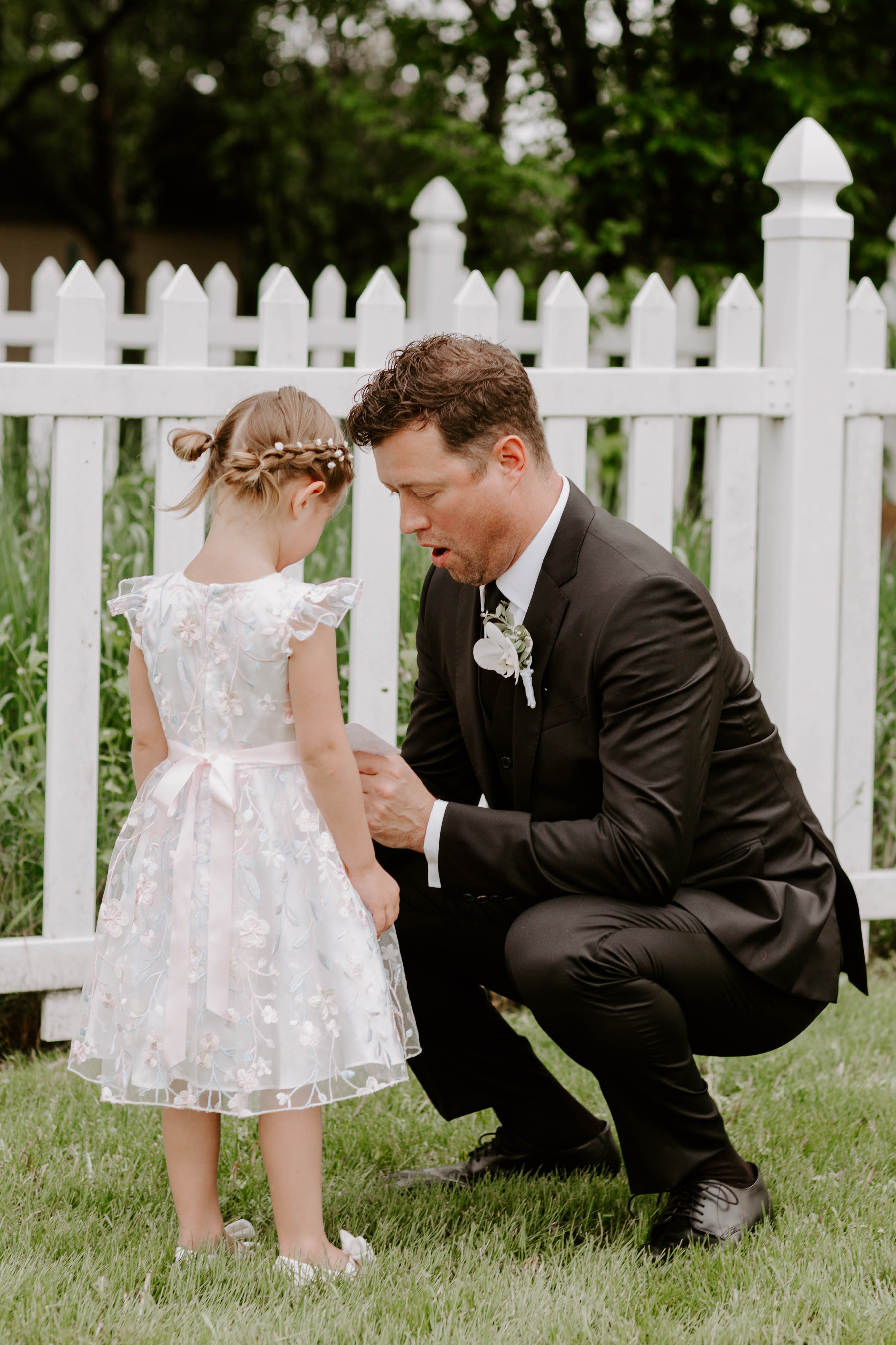 flower girl in lace dress with groom at backyard Chicago wedding