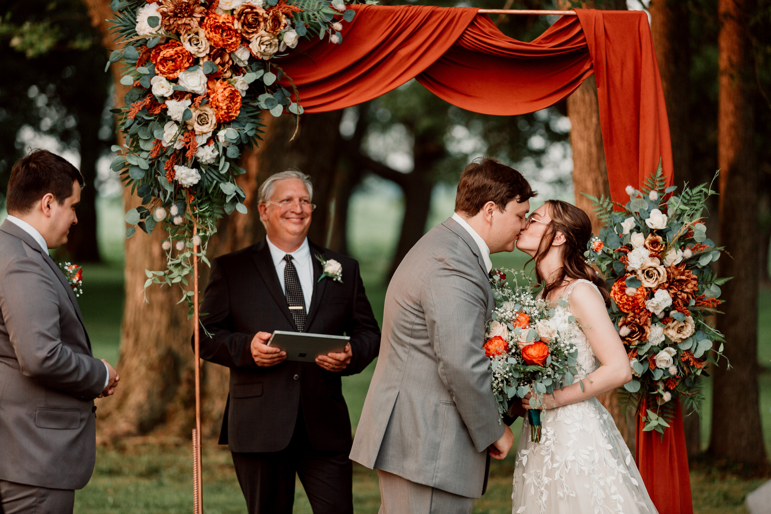 wedding arch with orange floral arrangement and fabric | Small Weddings Outdoors | Pecatonica Illinois