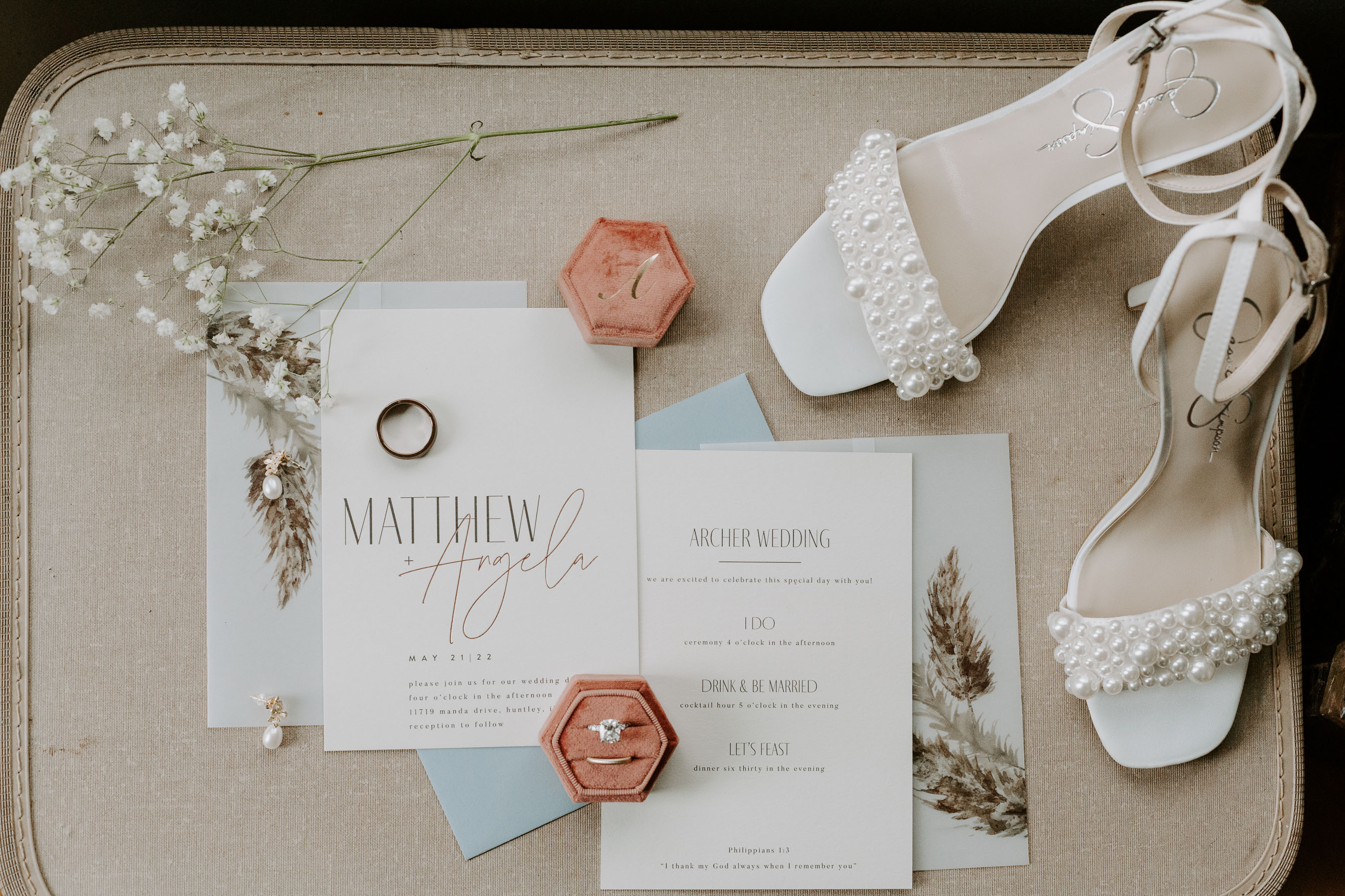 Wedding invitation suite detail photos with wedding rings, shoes, and flowers