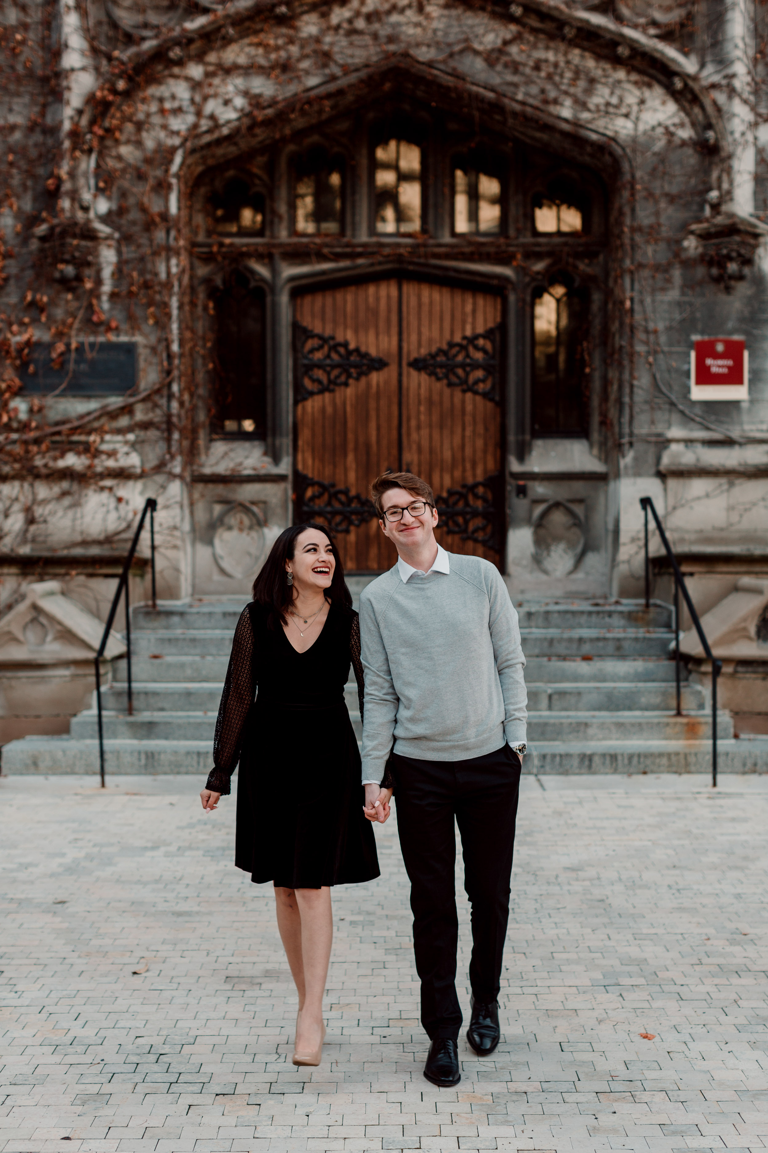 Engaged couple walking and laughing at engagement session | University of Chicago campus engagement session | Chicago engagement photographer | Chicago engagement photo locations | Winter engagement in Chicago | Where to take Chicago engagement photos | Chicago skyline engagement