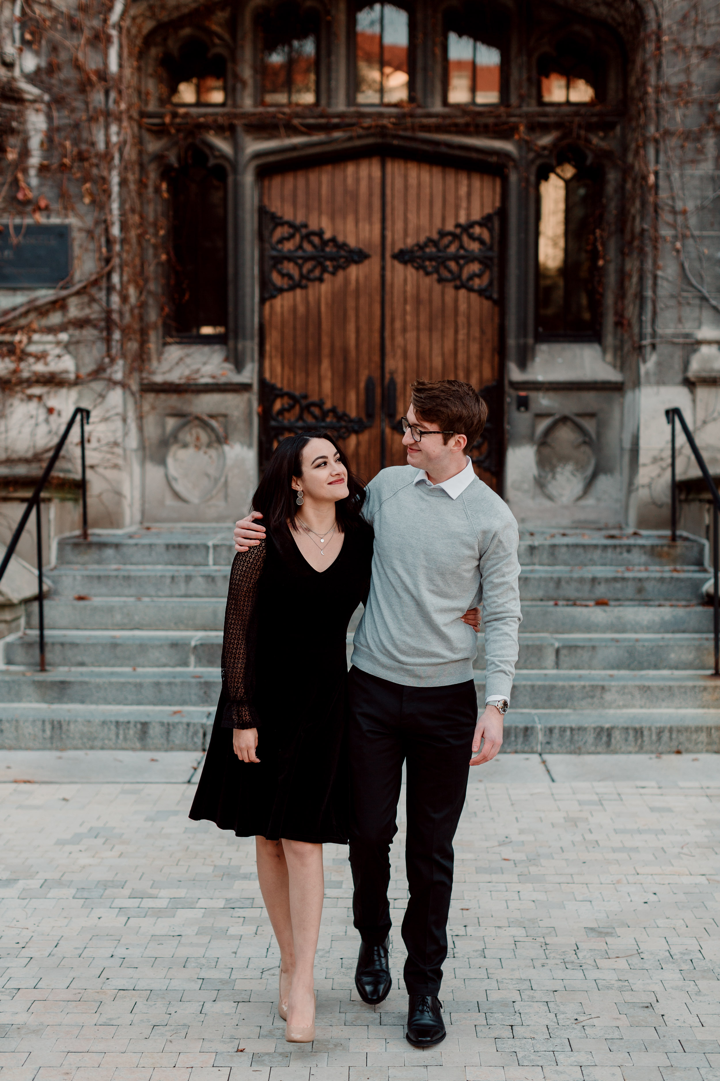 Chicago couple in front of university doors | University of Chicago campus engagement session | Chicago engagement photographer | Chicago engagement photo locations | Winter engagement in Chicago | Where to take Chicago engagement photos | Chicago skyline engagement