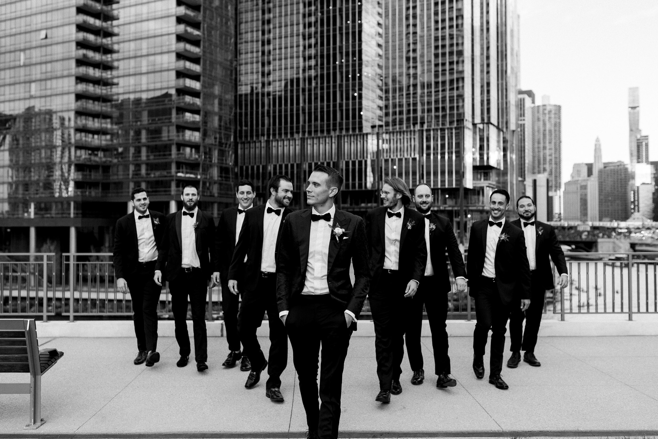Bridal party for downtown Chicago wedding on the river with skyline | groomsmen photos in black and white