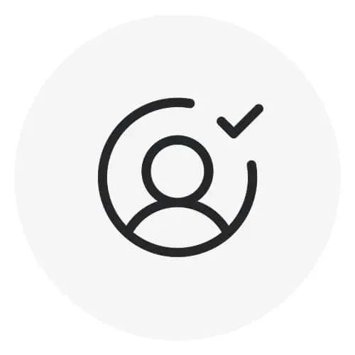 Dark gray icon of a person silhouette inside a circle with a checkmark, on a light gray circular background.