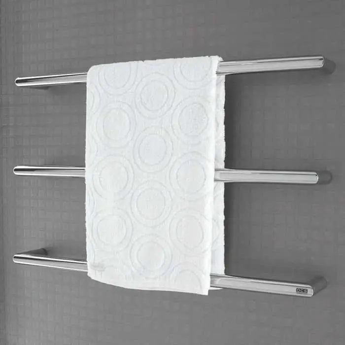 White patterned towel hanging on a modern stainless steel wall-mounted towel rack with three horizontal bars.