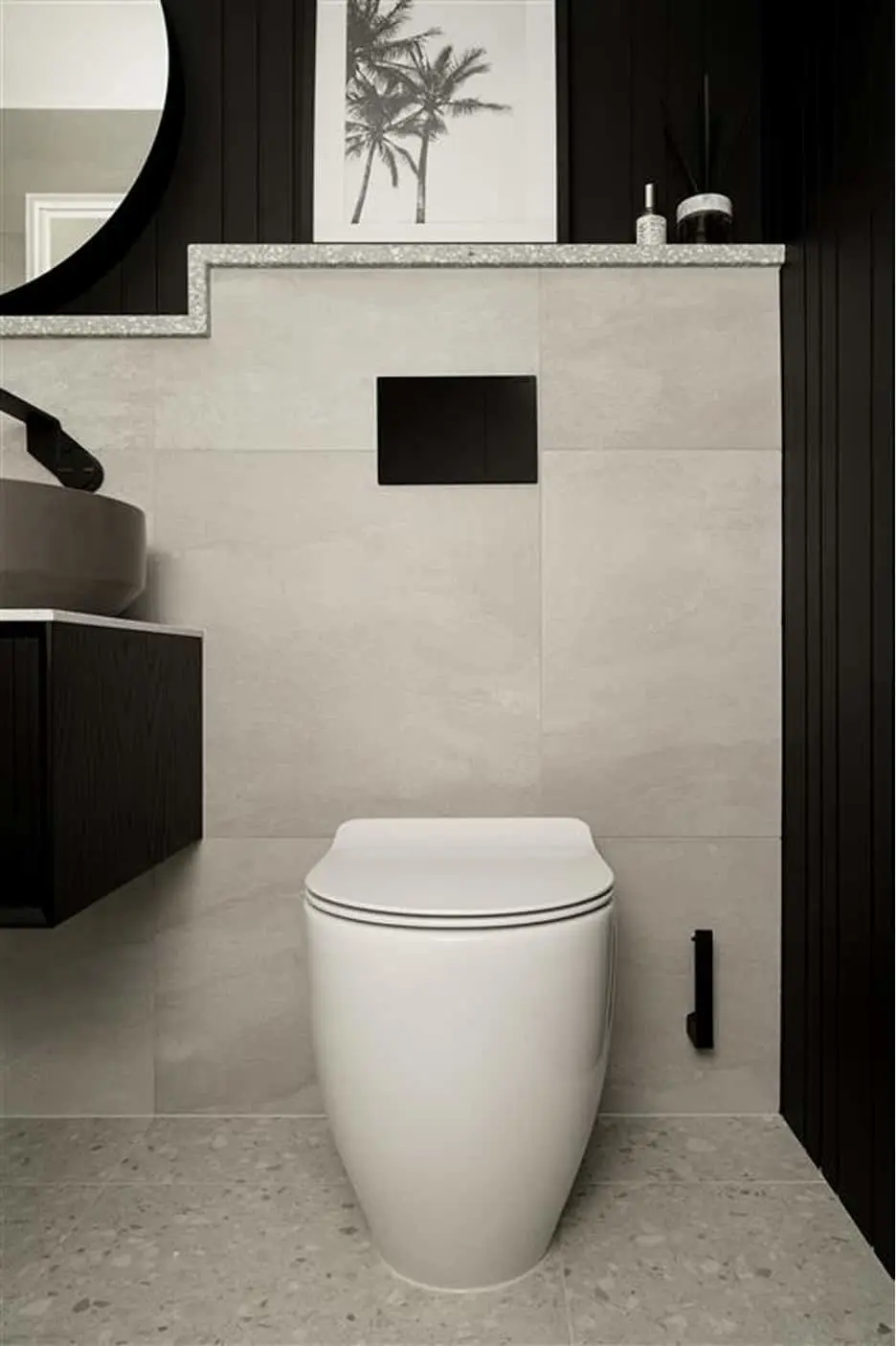Modern bathroom with white toilet, light tiles, black accents, and palm tree artwork on shelf above.