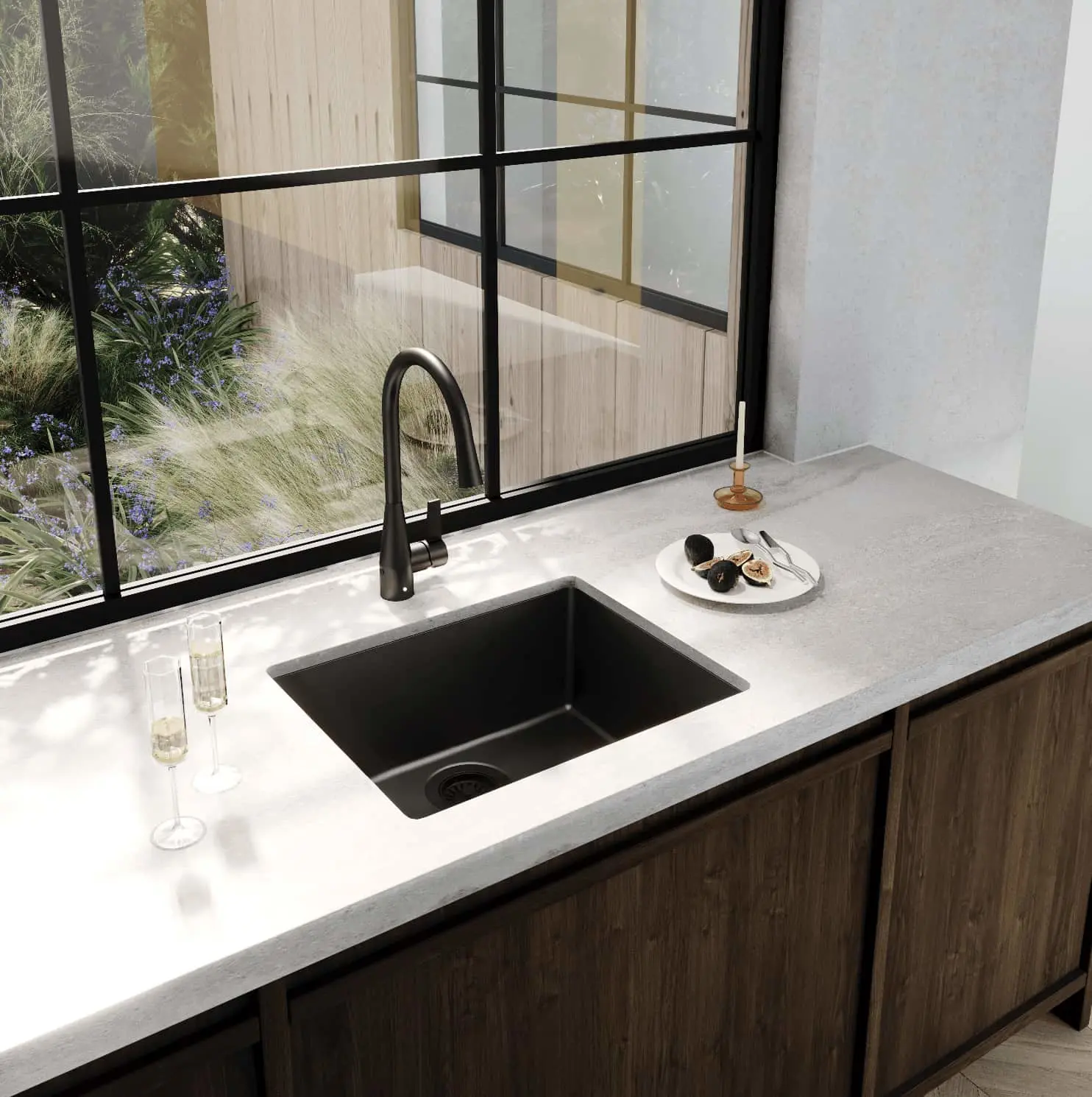 Modern kitchen sink with black faucet and basin on white countertop, large windows overlooking garden plants.