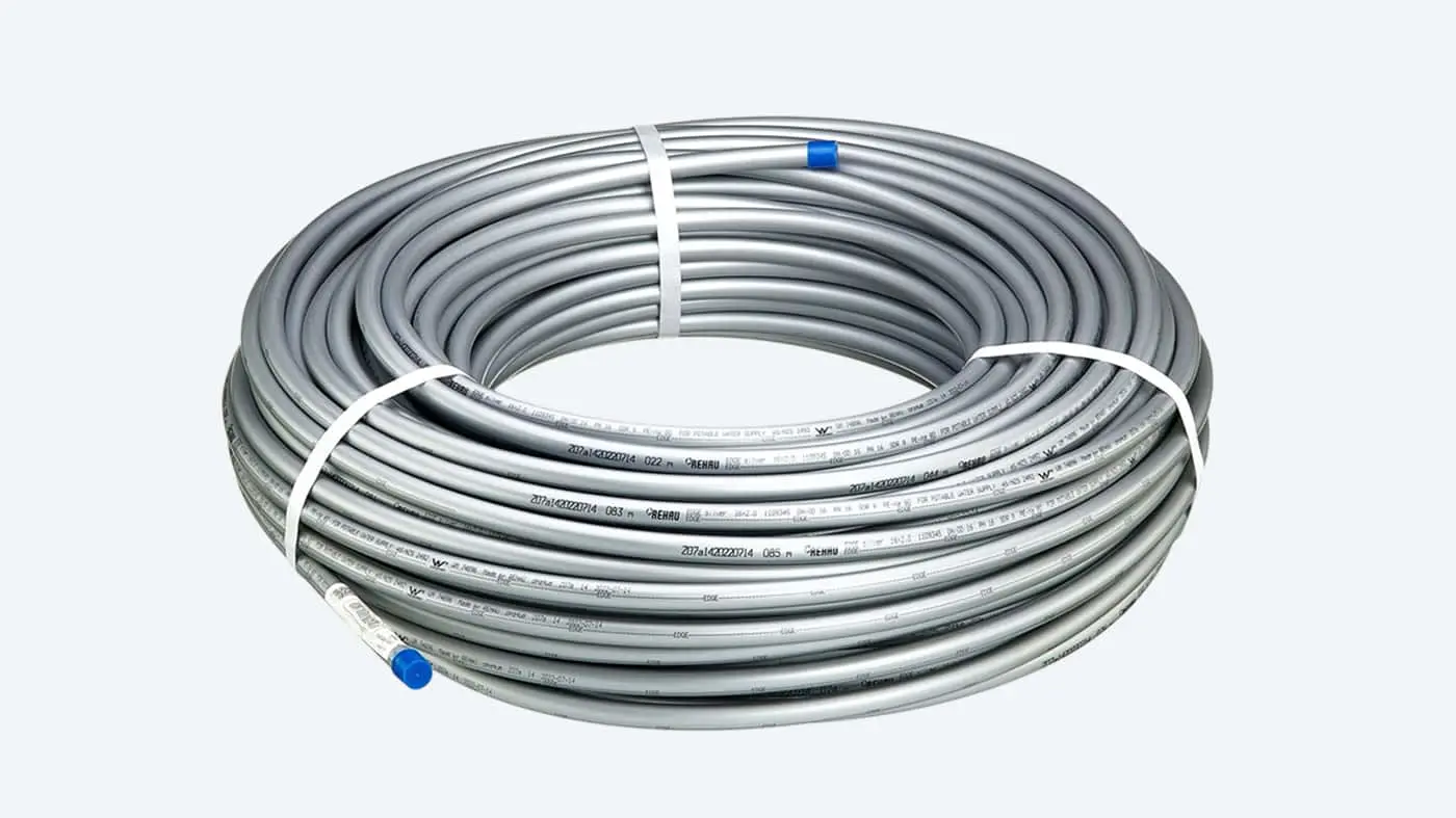 Coiled silver PEX plumbing pipe with blue end caps and white fastening straps on a white background.