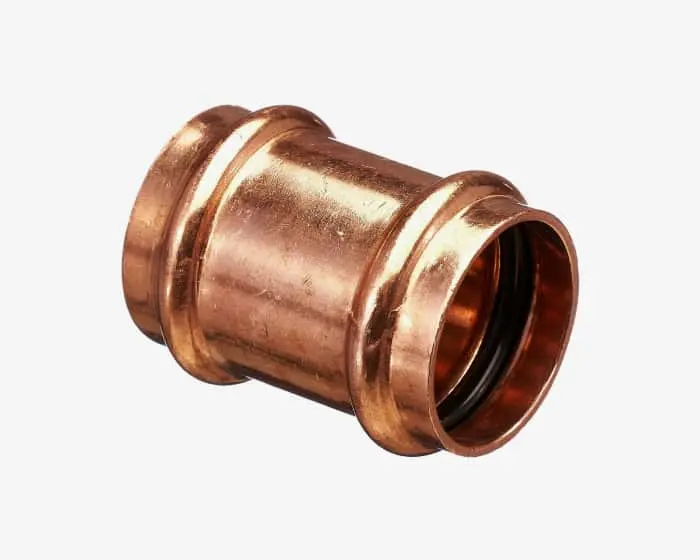 Shiny copper pipe fitting or connector with circular ridges at both ends, used for plumbing installations.
