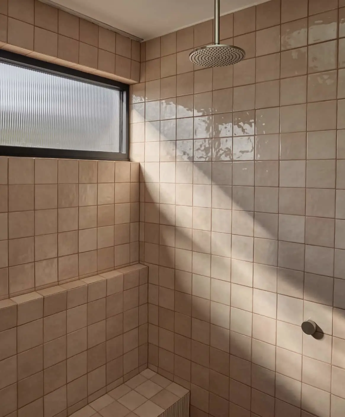 Modern bathroom with beige tiled shower featuring ceiling rainhead.