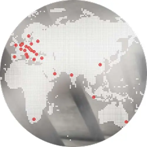 Circular world map with dotted pattern showing red location markers across Europe, Asia, and Australia, with a hand pointing.