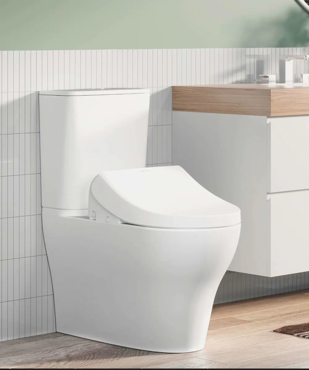 Modern white toilet with bidet seat next to wooden vanity cabinet in bathroom with vertical tile wall.