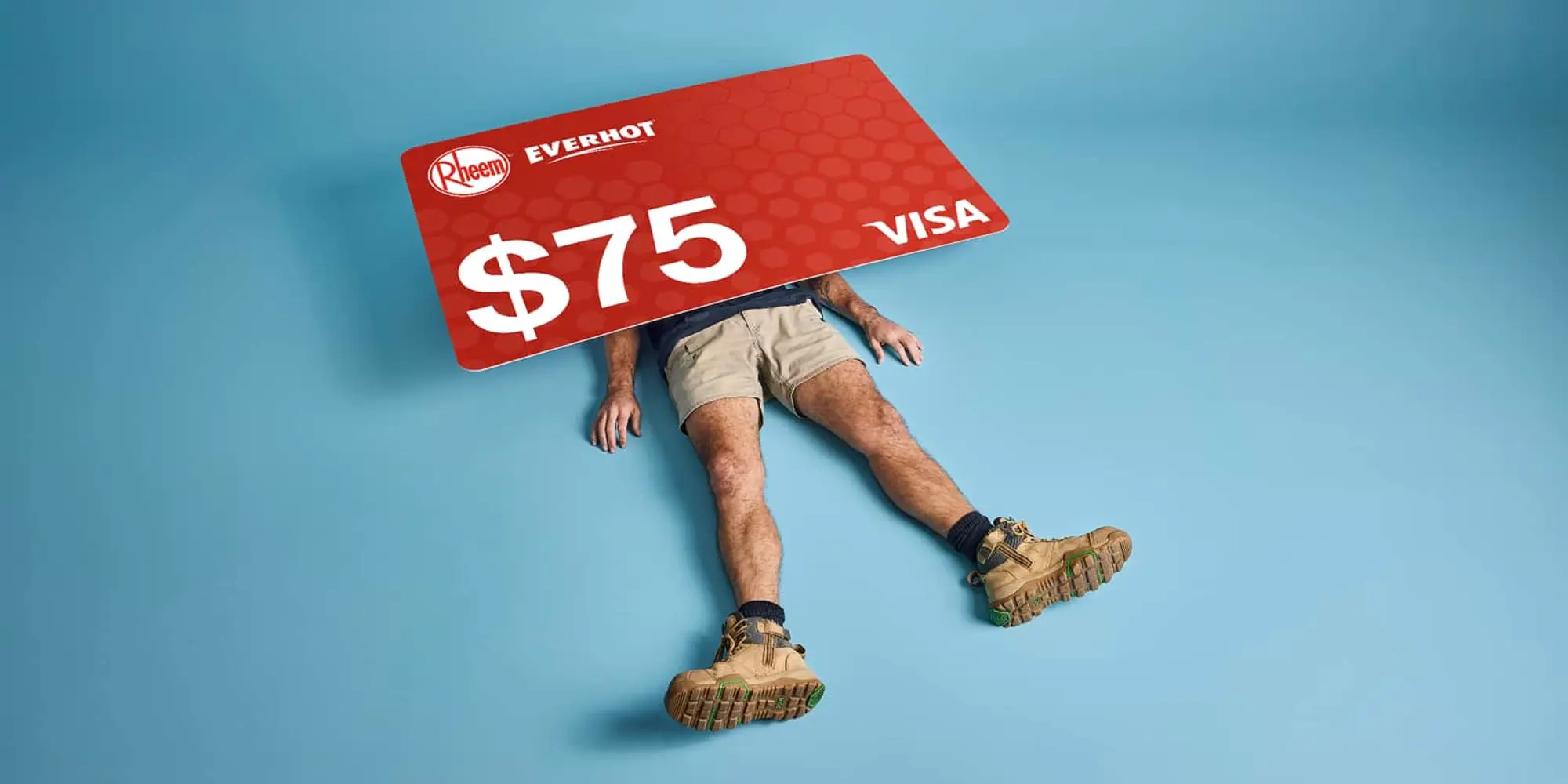 A large red Rheem Everhot $75 Visa gift card crushing a person wearing shorts and work boots on a blue background.