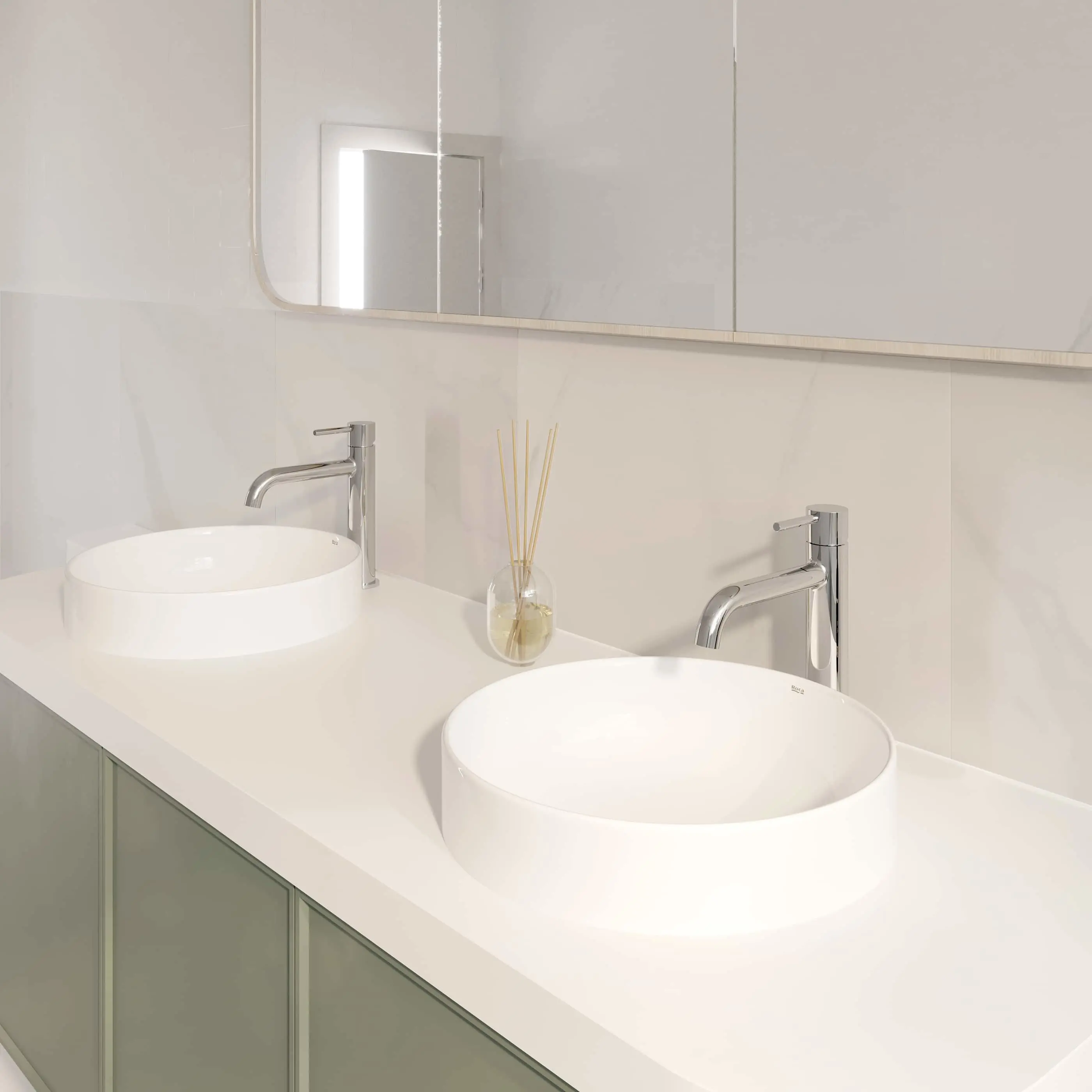 Modern bathroom vanity with dual white vessel sinks, chrome faucets, and reed diffuser on white countertop with mirror above.