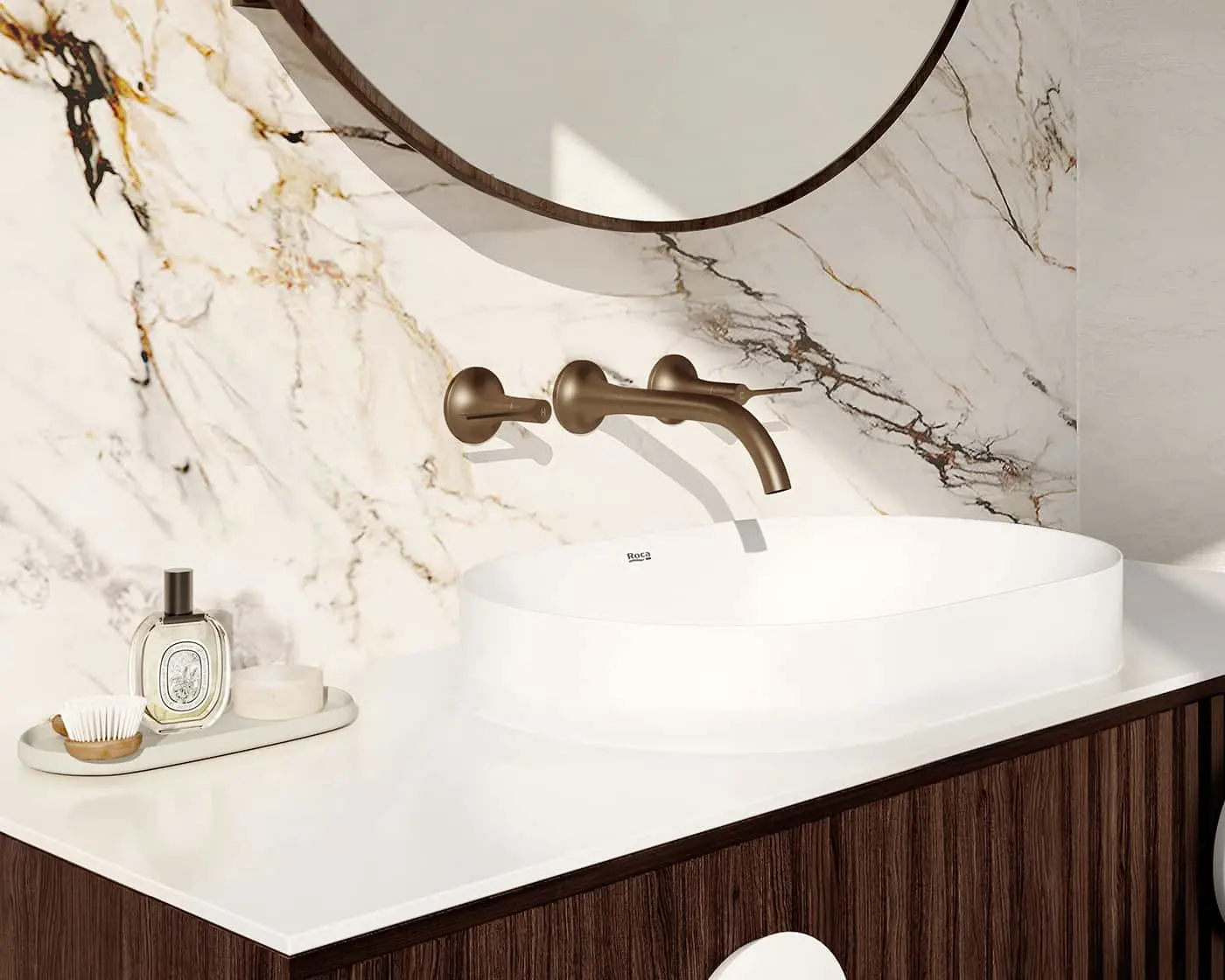 Modern bathroom with white vessel sink, bronze wall-mounted faucet, marble backsplash, and round mirror above dark wood vanity.