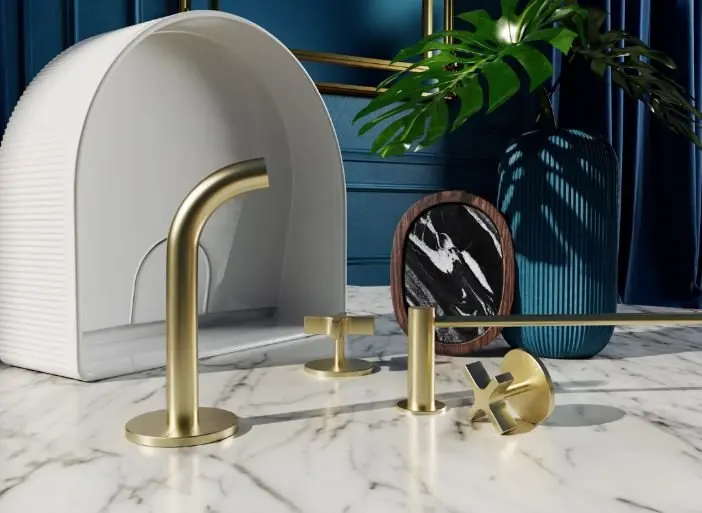 Modern bathroom fixture with gold faucet parts on marble countertop, blue wall background and decorative plants.