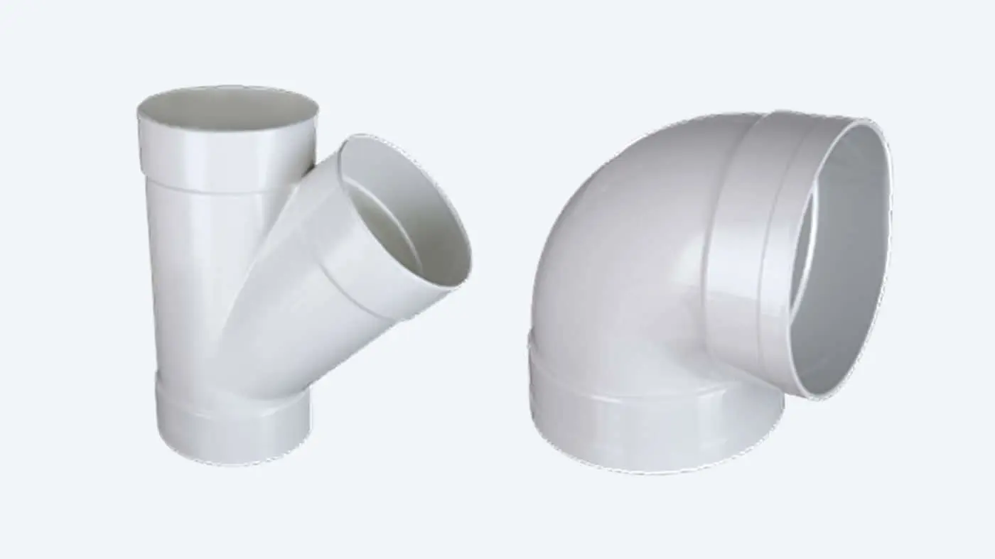 White PVC plumbing fittings: a Y-junction pipe connector on the left and a 90-degree elbow joint on the right.