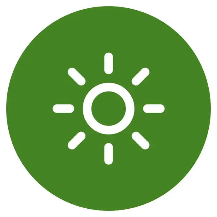 Green circular icon with white sun symbol featuring a center circle and radiating lines.