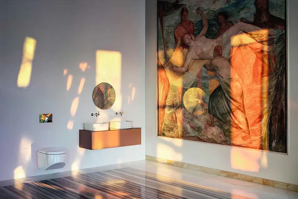 Modern bathroom with copper vanity, white sink, round mirror, and large Renaissance-style artwork on wall with warm light patterns.
