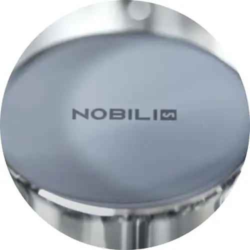 Black kitchen faucet with pull-down sprayer being used over sink with Nobili logo on tiled backsplash.