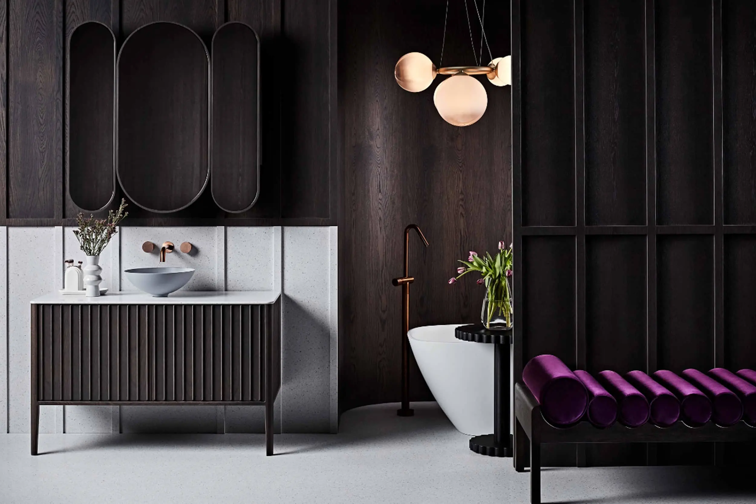Modern bathroom with dark wood paneling, white freestanding tub, vanity with bowl sink, and purple bench seating.