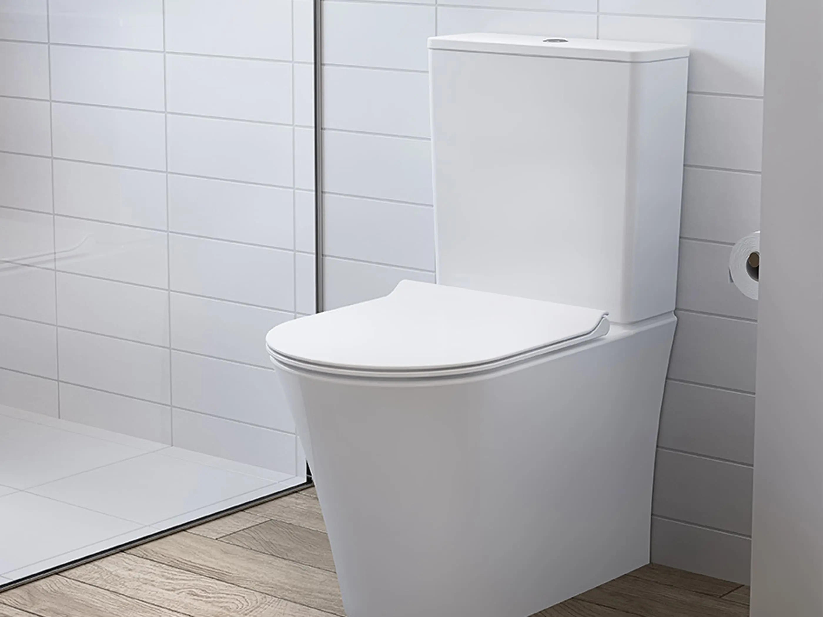 Modern white toilet with slim design against white tiled wall in bathroom with wooden floor.