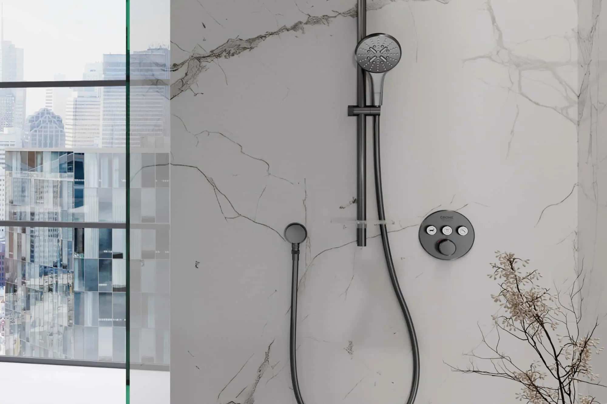 Modern shower with Grohe fixtures on marble wall, glass partition showing city skyline view, decorative plant branch.