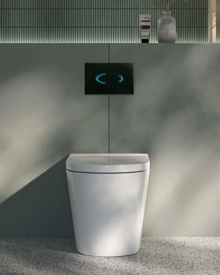 Modern white toilet with digital control panel displaying blue light indicators on a gray wall in minimalist bathroom.