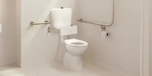 Accessible bathroom with white toilet, metal grab bars, and toilet paper holder in a clean tiled space.