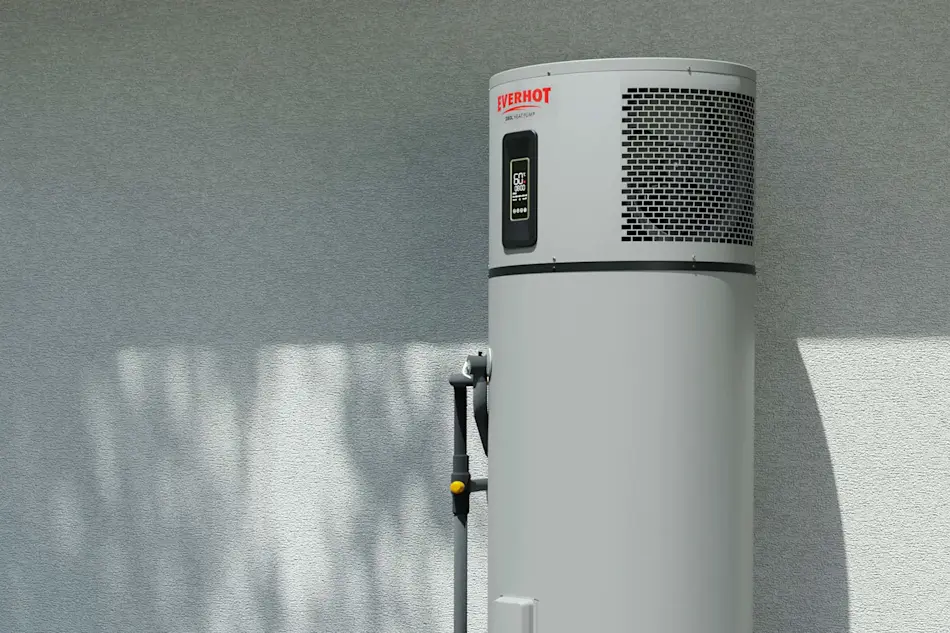 White Everhot water heater with digital display mounted against gray wall, casting shadow on the surface.