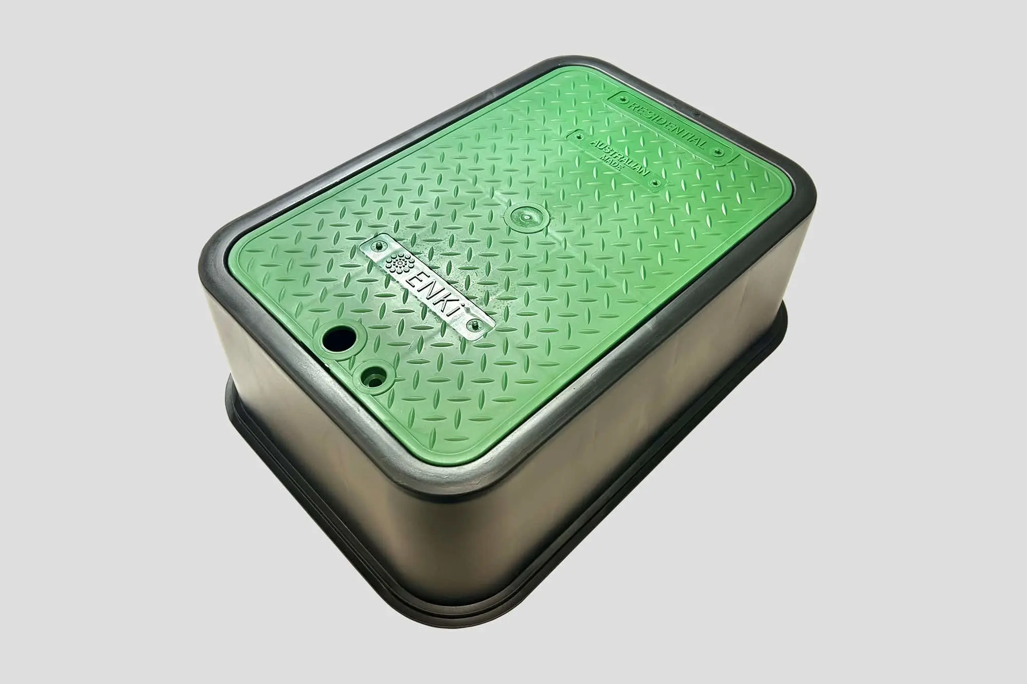 Green rectangular valve box with metal base and textured lid marked with ENKI branding and access holes.