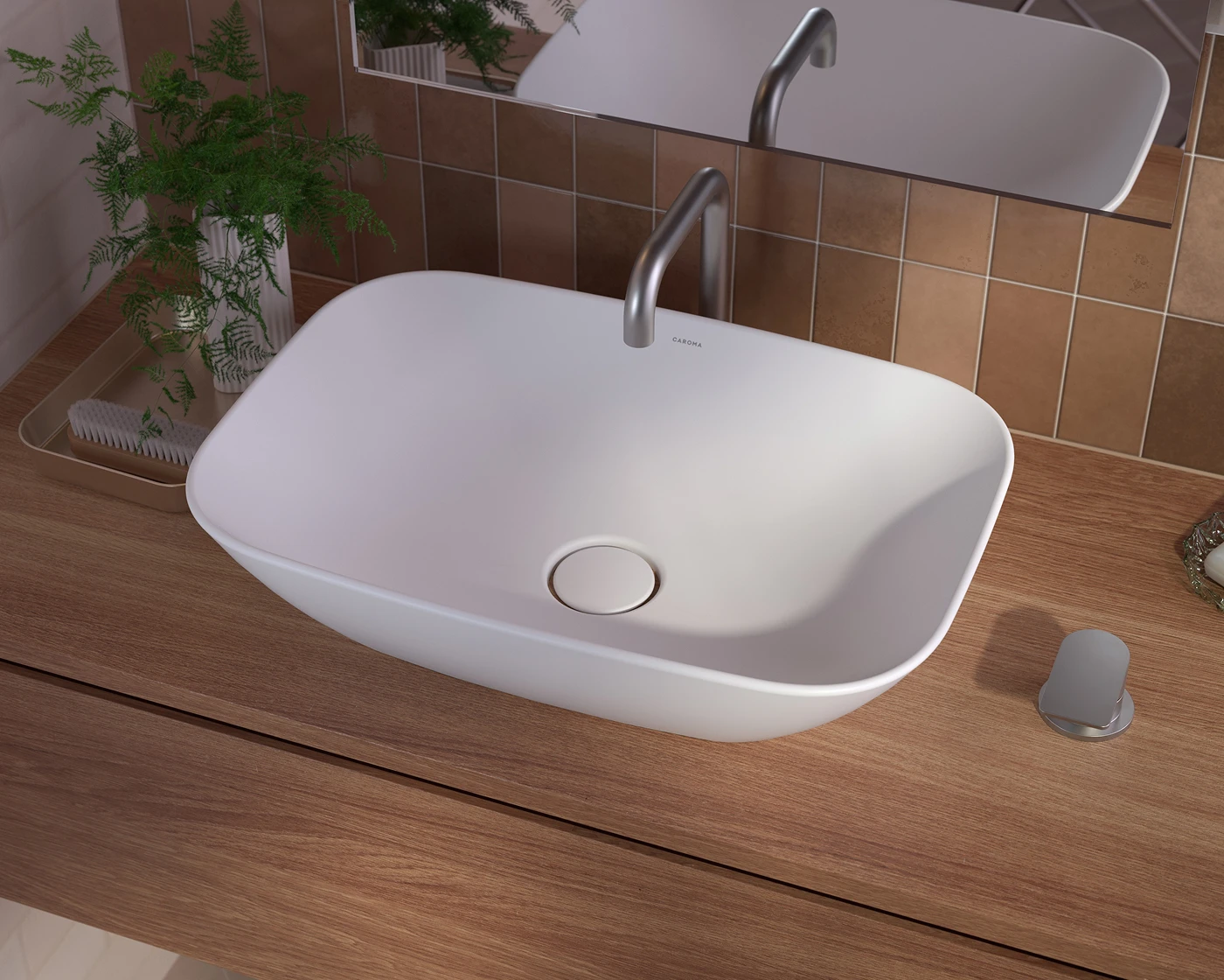 Modern white vessel sink with stainless steel faucet on wooden countertop, brown tiled wall, and small fern plant nearby.