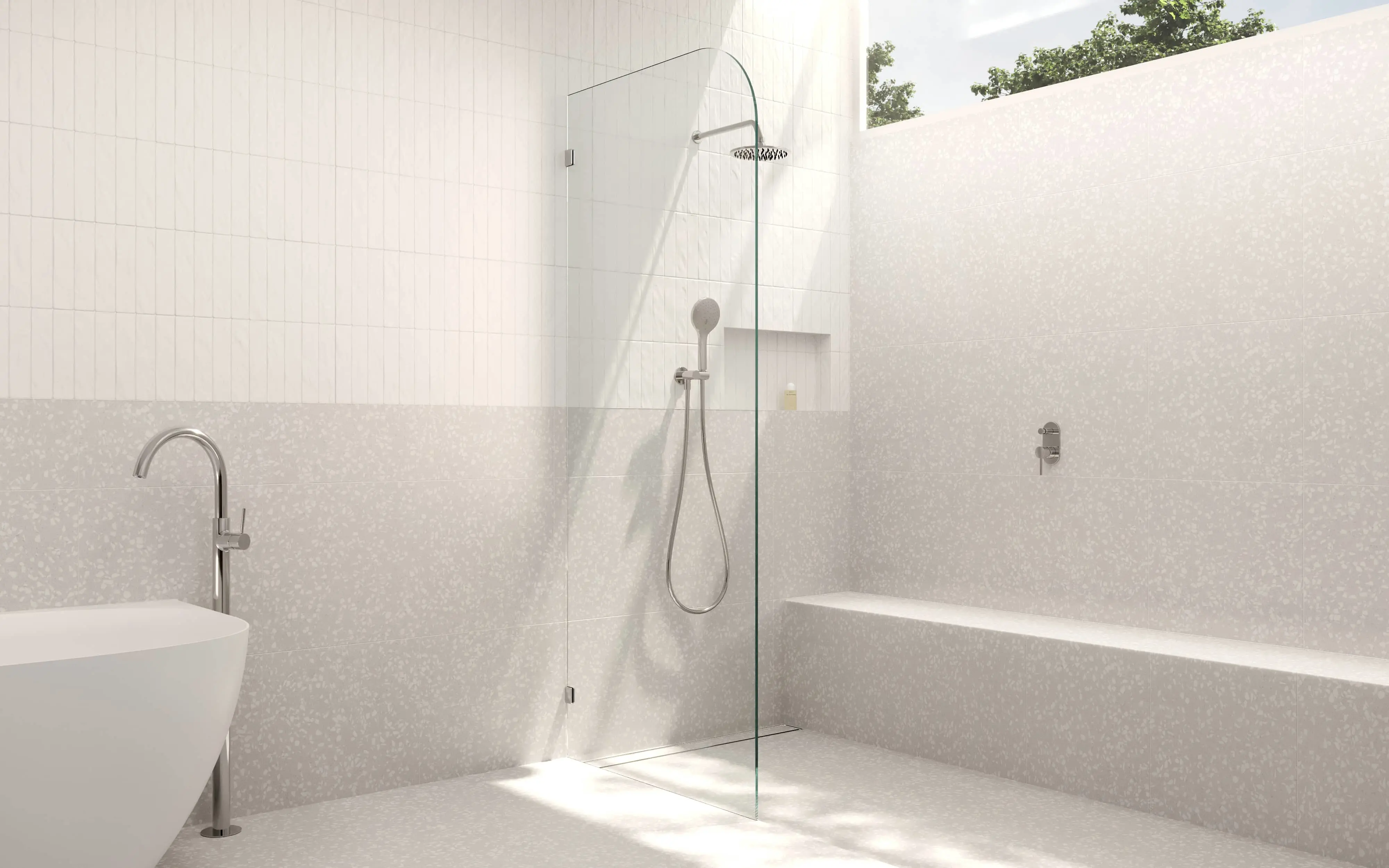 Modern minimalist bathroom with glass shower partition, white tiled walls, and natural light from above.