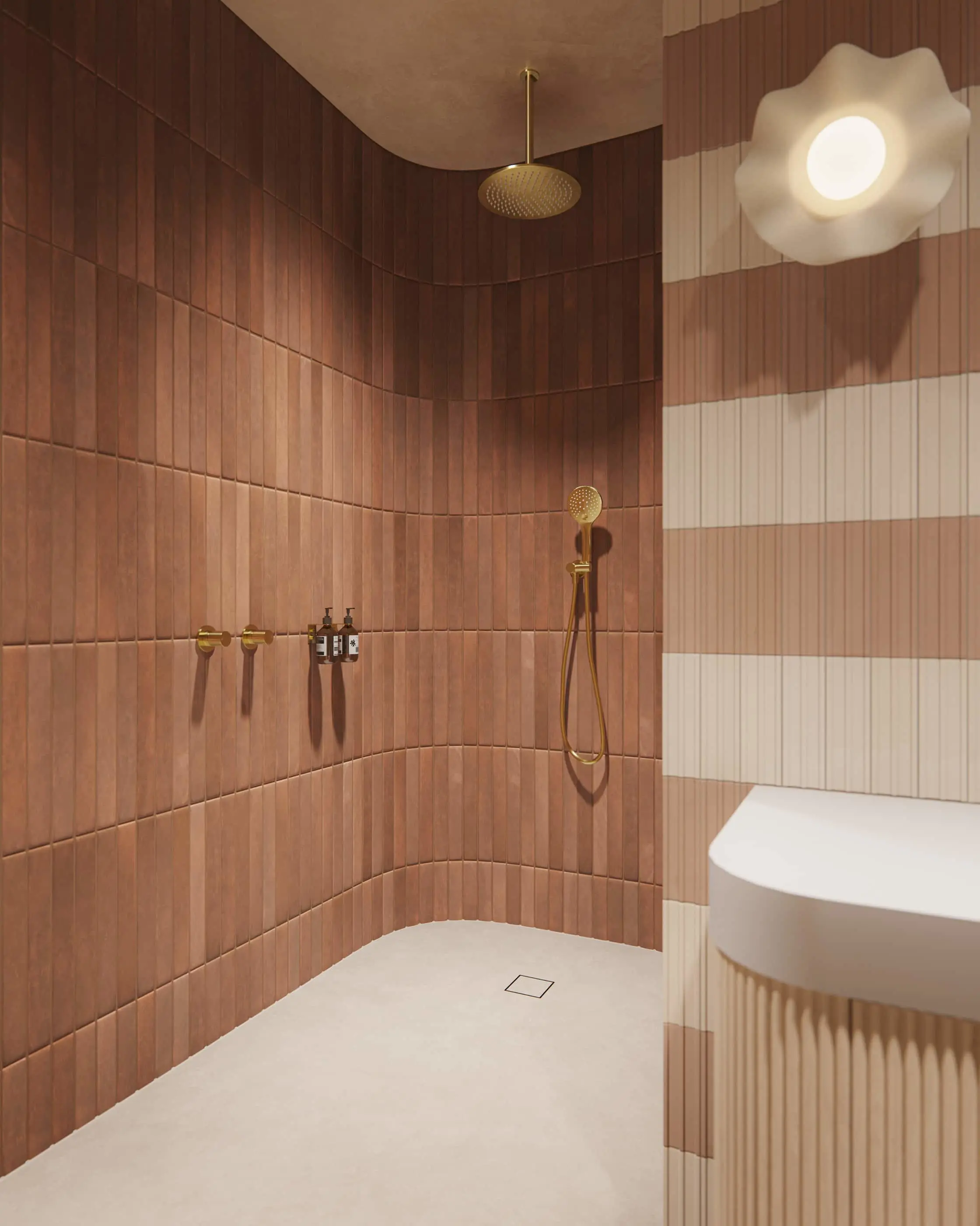 Modern shower with terracotta tile walls, brass fixtures, overhead rainfall showerhead, and white floor with drain.