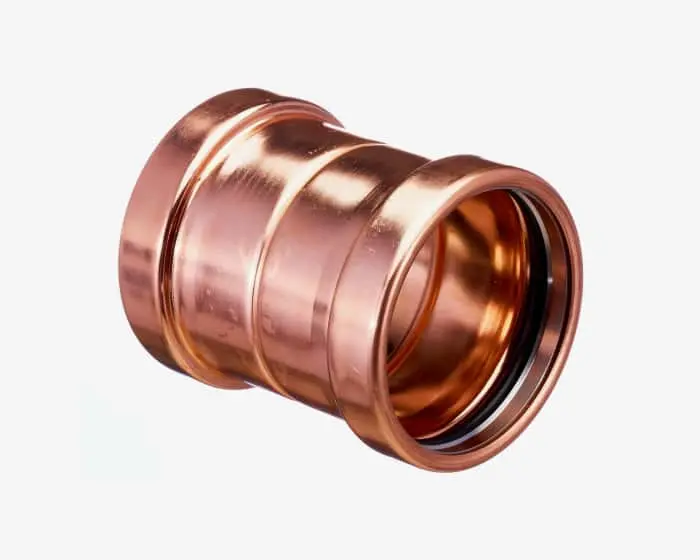 Copper pipe fitting with ridged edges and smooth metallic finish, used for plumbing connections.