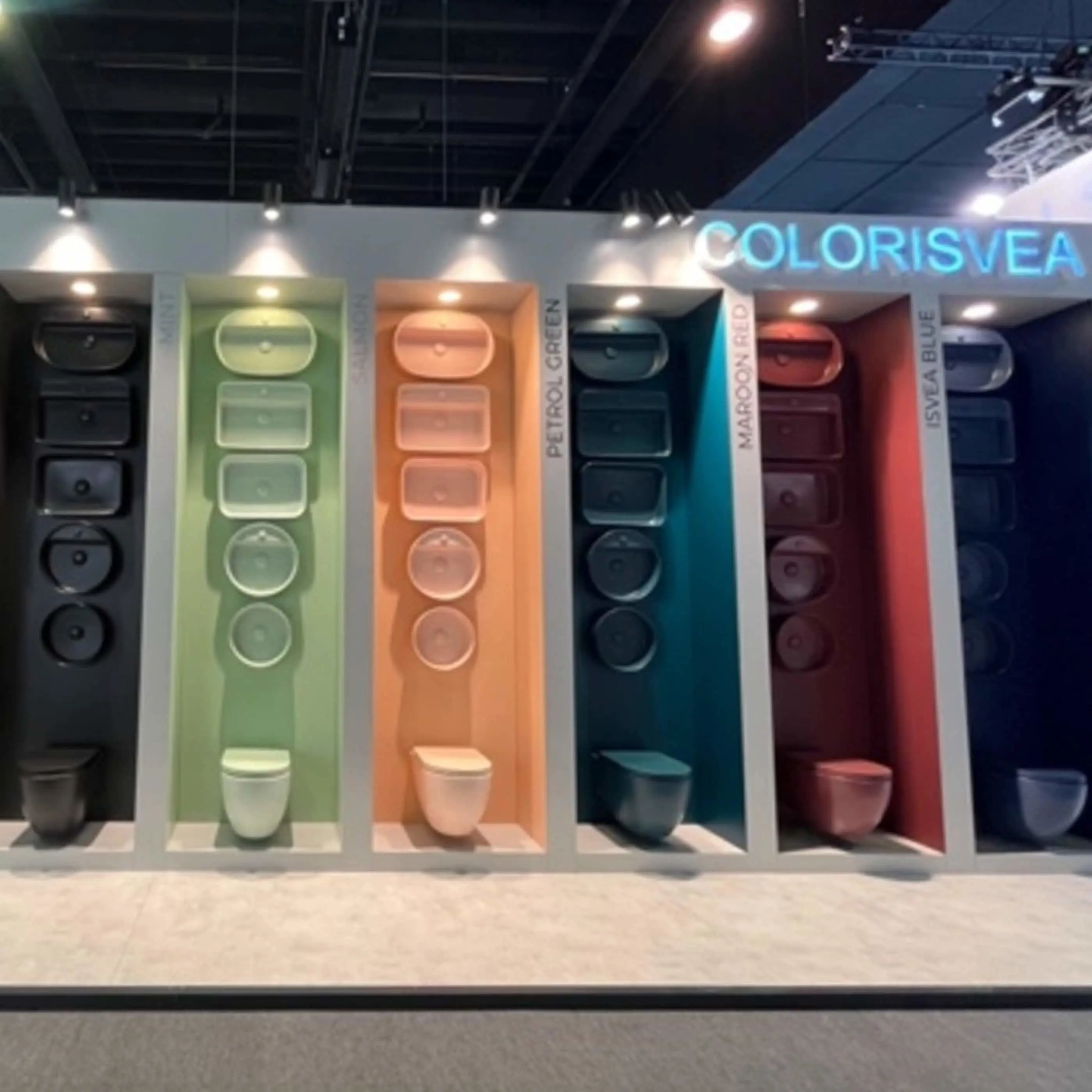 Colorful bathroom fixtures display with six different colored alcoves showing toilets and sinks under the COLORISVEA brand name.