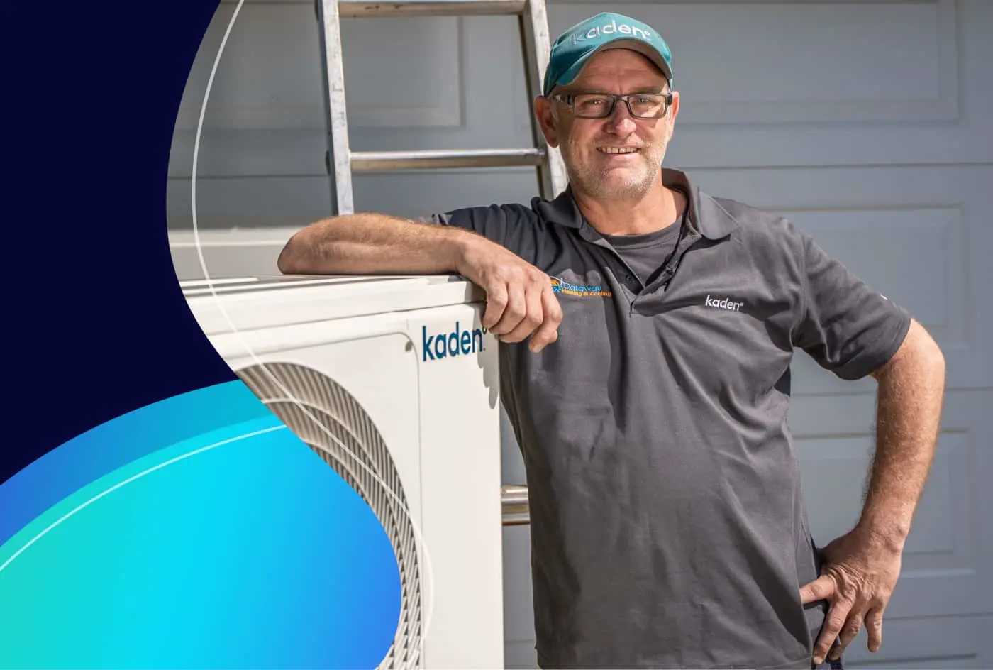 A tradesman in a Kaden uniform and cap leans on a Kaden air conditioning outdoor unit beside a ladder.