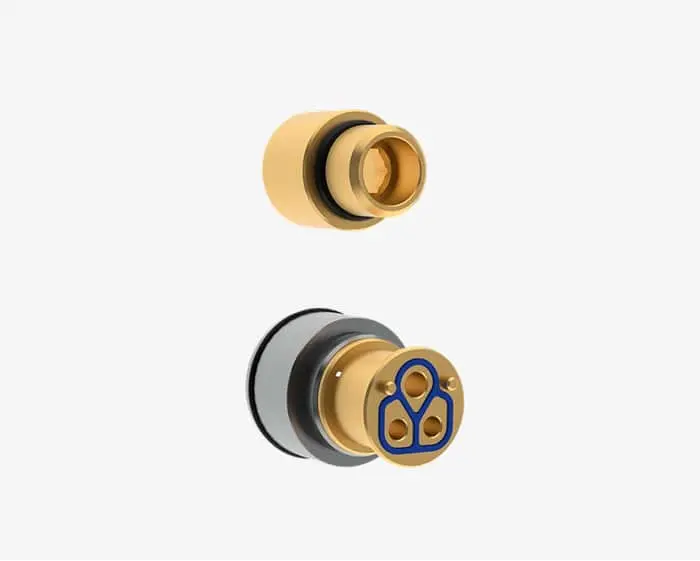 Gold plumbing fittings with blue symbol, showing two brass connector pieces against white background.