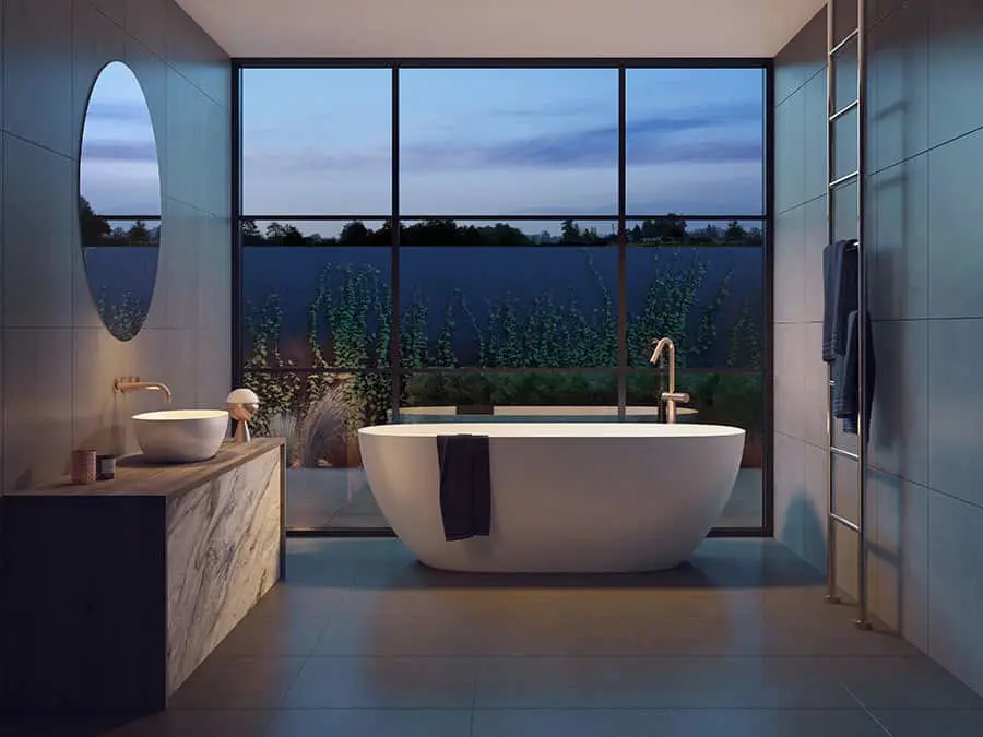 Modern bathroom with freestanding white tub, floor-to-ceiling windows overlooking twilight landscape, and marble vanity.