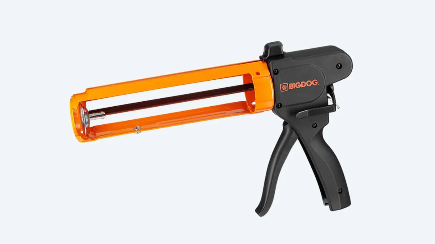 BIGDOG caulking gun with black handle and orange transparent cartridge holder against white background.