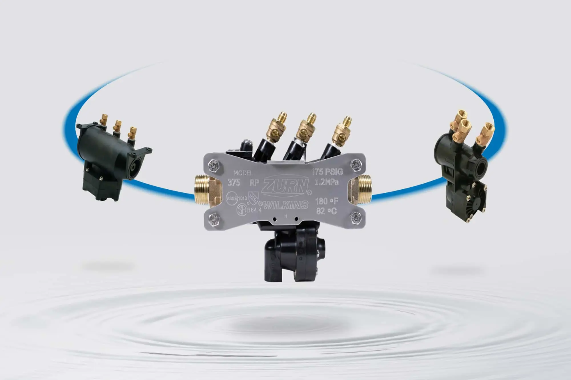 Zurn Wilkins Model 375 pressure regulator with brass fittings and connected valves against a light background.