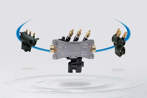 Zurn Wilkins Model 375 pressure regulator with brass fittings and connected valves against a light background.