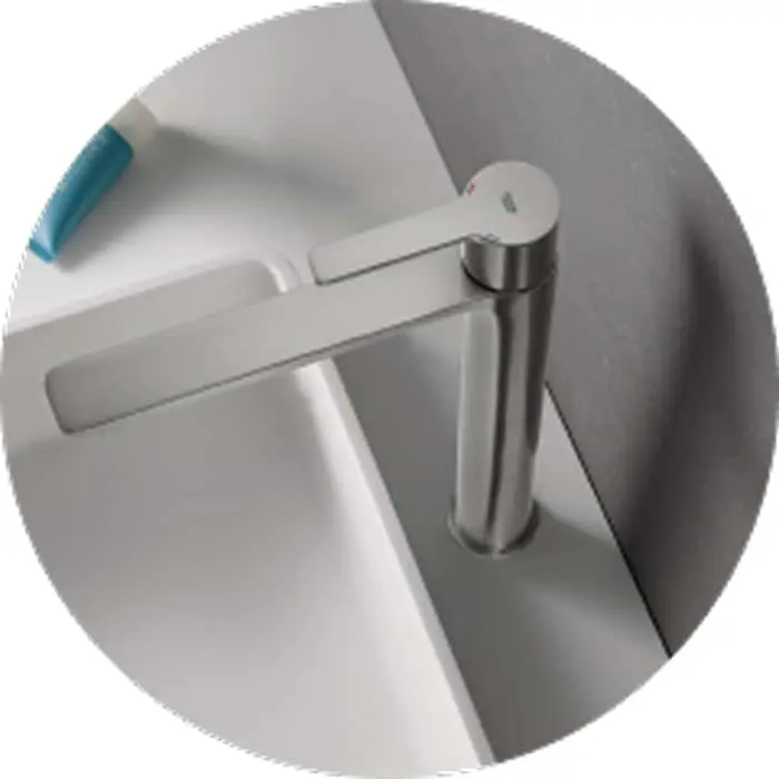 Modern stainless steel bathroom faucet with sleek lever handle mounted on a white sink basin.