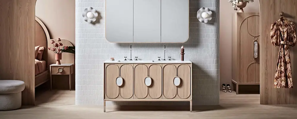 Modern bathroom with light wood vanity, white tile wall, mirror cabinet, and decorative wall sconces in warm neutral tones.